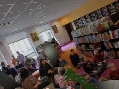 Grupa dzieci siedząca na ziemi.